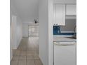 Spacious living room with neutral tile flooring, white walls, and seamless access to the kitchen at 601 N Hercules Ave # 1602, Clearwater, FL 33765