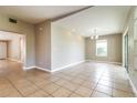 Bright living room with tile floors, a window, and access to the patio at 608 Lemonwood Dr, Oldsmar, FL 34677
