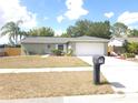 A well-maintained single-story home featuring a two-car garage, landscaped front yard, and neutral brick accents at 612 Bryan Terrace Dr, Brandon, FL 33511