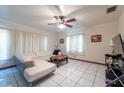 Bright living room with tile floors, ceiling fan, and large windows with natural light at 6321 S Harold Ave, Tampa, FL 33616