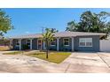 Charming single-story home with a well-manicured lawn and inviting curb appeal, side view on a sunny day at 6511 Georgia Ave, Bradenton, FL 34207