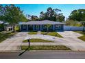 Charming single-story home with a well-manicured lawn and inviting curb appeal, front-facing elevated view on a sunny day at 6511 Georgia Ave, Bradenton, FL 34207