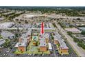 Aerial view of complex featuring a community pool, surrounded by lush landscaping, and ample parking in a well maintained community at 6800 20Th N Ave # 307, St Petersburg, FL 33710