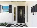 Elegant front entrance showcasing a decorative door, black and white tiled foyer, and stylish accents at 722 61St S Ave, St Petersburg, FL 33705