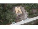 Aerial view of home under construction shows roof framing and a wooded lot at 8149 Cashew, Webster, FL 33597