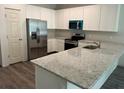 Bright kitchen features white cabinets, stainless steel appliances, and a large granite countertop island at 8149 Cashew, Webster, FL 33597