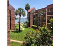 Beautiful landscaped grounds featuring sidewalks, tropical trees, and colorful flowers in this waterfront community at 8931 Blind Pass Rd # 257, St Pete Beach, FL 33706