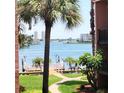 Lovely view of waterfront with mature palm trees and manicured grounds at 8931 Blind Pass Rd # 257, St Pete Beach, FL 33706