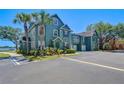 Inviting home exterior featuring lush landscaping, ample parking and a serene waterfront view at 9304 Lake Chase Island Way, Tampa, FL 33626