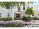 Charming two-story townhouse featuring a well-maintained front yard and a serene, inviting entrance at 9628 Charlesberg Dr, Tampa, FL 33635