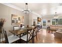 Inviting dining area flowing into a living room with hardwood floors at 9727 Tiffany Oaks Ln, Tampa, FL 33612