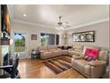Cozy living area boasting hardwood floors and peaceful lake views at 9727 Tiffany Oaks Ln, Tampa, FL 33612
