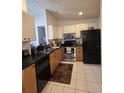 Functional kitchen with stainless steel appliances, laminate countertops, and ample cabinet space at 10918 Freemont Dr, New Port Richey, FL 34654