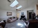 Bright living room with skylights, ceiling fan and comfortable seating at 10918 Freemont Dr, New Port Richey, FL 34654