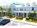 Townhome exterior with lush landscaping, a sidewalk, and a covered entryway under a bright blue sky at 11622 Declaration Dr, Tampa, FL 33635