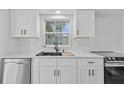Stylish kitchen featuring a sleek sink, modern faucet, and white cabinetry at 1225 58Th N St # 204A, St Petersburg, FL 33710