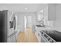 Modern kitchen with stainless steel appliances, white cabinets, and updated countertops at 1225 58Th N St # 204A, St Petersburg, FL 33710