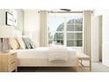 Bright bedroom featuring large windows, neutral color scheme, a bed with decorative pillows, and hardwood side table at 13135 Empress Jewel Trl, Parrish, FL 34219