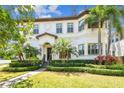 Attractive two-story home with manicured lawn, lush landscaping, and a tile roof at 134 Chesapeake Ave, Tampa, FL 33606