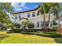 Beautiful two-story home showcases manicured lawn, lush landscaping, and a tile roof at 134 Chesapeake Ave, Tampa, FL 33606