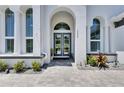 Grand entrance with double doors, stone pathway, and elegant architectural details at 13539 Carryback Dr, Dade City, FL 33525
