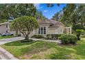 Beautiful home exterior with manicured lawn and driveway with parked vehicle at 15314 Sherwood Forest Dr, Tampa, FL 33647