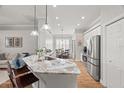 Modern kitchen featuring stainless steel appliances, granite countertops, and an open layout at 15417 Martinmeadow Dr, Lithia, FL 33547