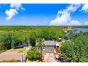 Aerial view showcasing a home near a river in a lush, green neighborhood at 2635 Manatee Harbor Dr, Ruskin, FL 33570