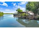 Dock with boat lift extending into the calm and picturesque river at 2635 Manatee Harbor Dr, Ruskin, FL 33570