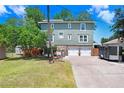 The exterior of this home features an attached two-car garage and stone foundation at 2635 Manatee Harbor Dr, Ruskin, FL 33570