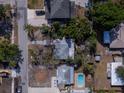 Overhead shot of a home in a suburban neighborhood, surrounded by trees and other houses at 3021 W Helen Ave, Tampa, FL 33611