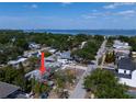 Scenic aerial view of a neighborhood with mature trees and a glimpse of the ocean in the background at 3021 W Helen Ave, Tampa, FL 33611