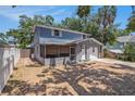 Two-story home with a fenced yard, a covered porch, and a one-car garage at 3115 W Wyoming Ave, Tampa, FL 33611