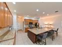 Spacious kitchen featuring granite countertops, stainless steel appliances, and a large island with bar seating at 3254 Grassglen Pl, Wesley Chapel, FL 33544