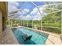 A serene screened-in pool area for relaxation and recreation with an outdoor dining set at 3254 Grassglen Pl, Wesley Chapel, FL 33544