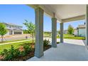 Comfortable porch shows landscaping in a newly constructed community at 37194 Clinch Cir, Zephyrhills, FL 33540