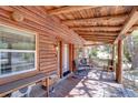 Inviting front porch with wooden ceiling and comfortable seating area at 4126 Burrows Rd, Zephyrhills, FL 33542