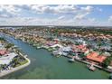 Stunning aerial view of waterfront home with boat dock and bay access, surrounded by lush landscaping and neighboring houses at 4333 48Th S Ave, St Petersburg, FL 33711