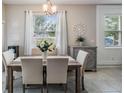 Bright dining room featuring a stylish chandelier, modern decor, and plenty of natural light at 4550 Globe Thistle Dr, Tampa, FL 33619