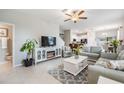 Inviting living room with modern decor, tile flooring, and a cozy fireplace feature at 4550 Globe Thistle Dr, Tampa, FL 33619