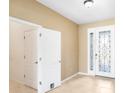 Inviting foyer with tile flooring and a decorative front door, creating a warm entrance at 5453 Suncatcher Dr, Wesley Chapel, FL 33545