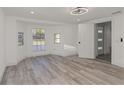Bright bedroom featuring wood-look flooring, natural light, and a modern ceiling fan at 6136 56Th N Ave, St Petersburg, FL 33709