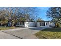 Charming single-story home with a well-maintained lawn and a concrete driveway at 6136 56Th N Ave, St Petersburg, FL 33709