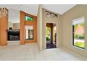 Bright entryway featuring neutral walls, white tile flooring, and clerestory window with stained glass accent at 713 Dorado Ct, Brandon, FL 33511