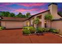 Inviting single-Gathering home with a 2-car garage, chimney, mature landscaping, and a red brick driveway at 713 Dorado Ct, Brandon, FL 33511