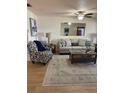 Cozy living room showcasing stylish furniture, neutral decor, and a ceiling fan for added comfort, creating an inviting atmosphere at 9117 41St N Way # 5, Pinellas Park, FL 33782