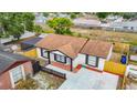 An aerial view of the property showcasing the roof, fenced yard and surrounding neighborhood at 9201 Spy Glass Ct, Tampa, FL 33615
