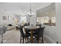 Cozy breakfast nook features a marble table, four leather chairs, and a view into the living area at 9723 Rolling Cir, San Antonio, FL 33576