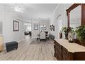 Elegant dining room with light wood floors, modern chandelier, and decorative dresser with marble top at 9723 Rolling Cir, San Antonio, FL 33576