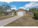 Single Gathering home featuring an attached garage and driveway at 10016 Glen Moor Ln, Port Richey, FL 34668